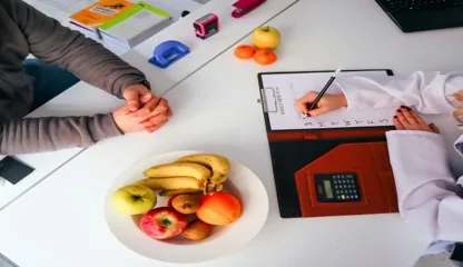 Nutrition practitioner reviewing client records, meal plans and follow-ups in a modern practice platform.